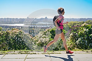 Woman runner run commutes to work with backpack, city morning run commuting and fitness concept