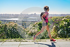 Woman runner run commutes to work with backpack, city morning run commuting and fitness concept