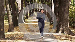 Woman runner run in the park goes for sports. runner athlete girl running on trail nature. woman on morning jog green