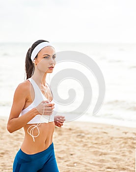 Woman runner running on the beach