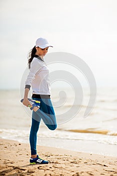 Woman runner running on the beach