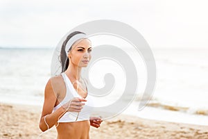 Woman runner running on the beach
