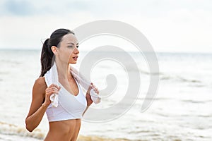 Woman runner running on the beach