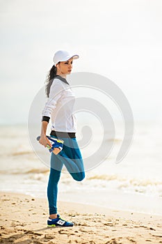 Woman runner running on the beach