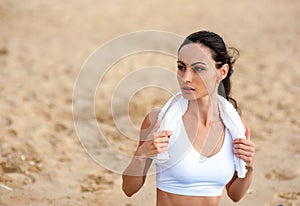 Woman runner running on the beach