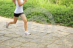 Woman runner running at forest trail