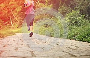 Woman runner running at forest trail