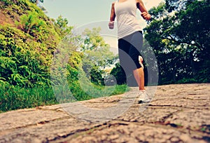 Woman runner running at forest trail