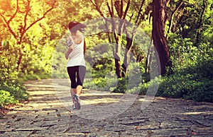 Woman runner running at forest trail