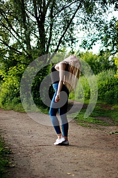 Woman runner running jogging in summer park, throw up head.