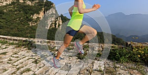 Woman runner running on mountain top