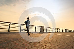 Woman runner running at seaside