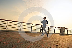 Woman runner running at seaside