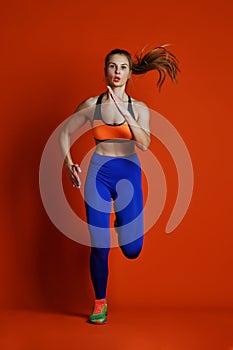Woman runner in silhouette isolated on red background. Dynamic movement. Sport and healthy lifestyle