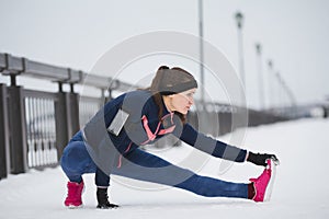 Woman runner stretching legs before run. Young athlete woman working out. Fitness concept.