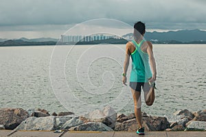 woman runner stretching legs before running