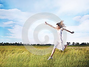 Woman running across field