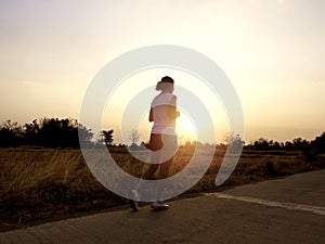 Woman running alone at beautiful sunset.