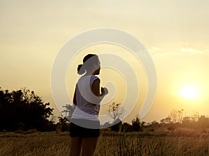 Woman running alone at beautiful sunset.