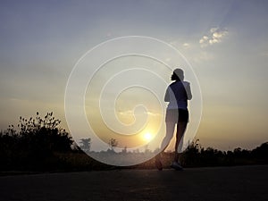 Woman running alone at beautiful sunset.