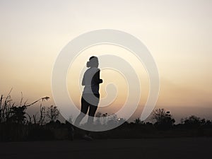 Woman running alone at beautiful sunset.