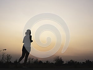 Woman running alone at beautiful sunset.