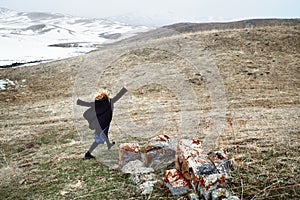 Woman running away in the snow landscape
