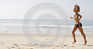 Woman Running On The Beach