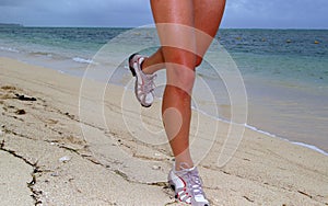 Woman running on beach with sea shoreline background