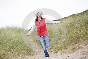 Woman running at beach smiling