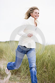 Woman running at beach smiling