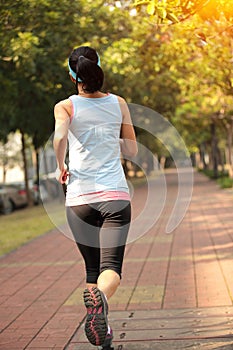 Woman running at city park