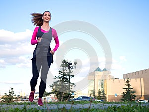 Woman running in a city park. Healthy lifestyle concept.