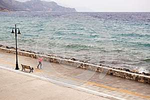 Woman running on city street at seaside photo