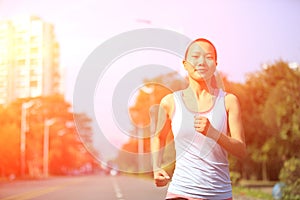 Woman running at city street