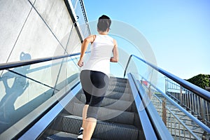Woman running on escalator stairs