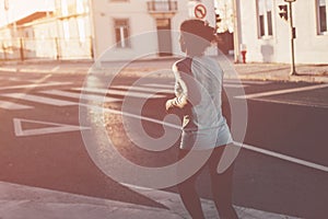 Woman running in the evening on the street. Urban workout