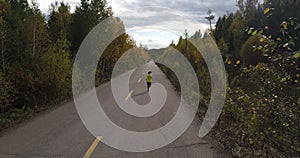 Woman running on forest trail