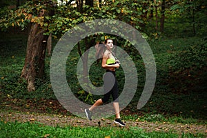 Woman running in green park, healthy lifestyle background
