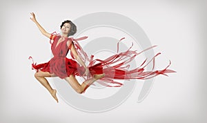 Woman Running in Jump, Girl Performer Leap Dancing in Red Dress photo