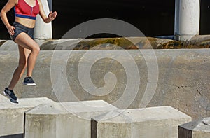 Woman running, jumping obstacles, without showing her face