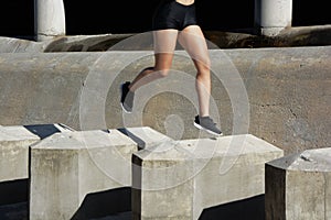 Woman running, jumping obstacles, without showing her face