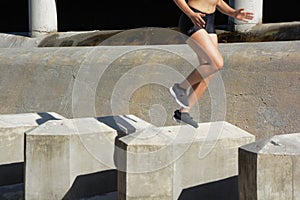 Woman running, jumping obstacles, without showing her face