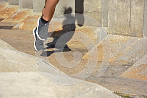 Woman running, jumping obstacles, without showing her face