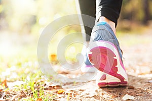 Woman running legs in sunset forest