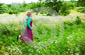 Woman running on a meadow