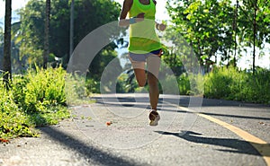 woman running on morning tropical forest trail