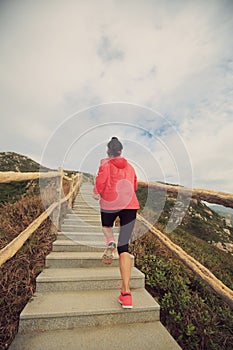 Woman running on mountain stairs
