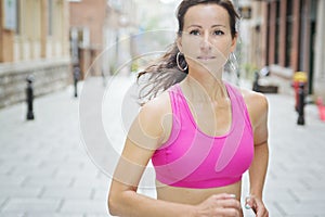 Woman running outdoors training for marathon run