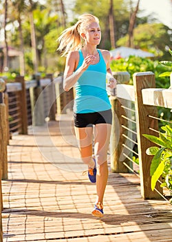Woman running outside along path